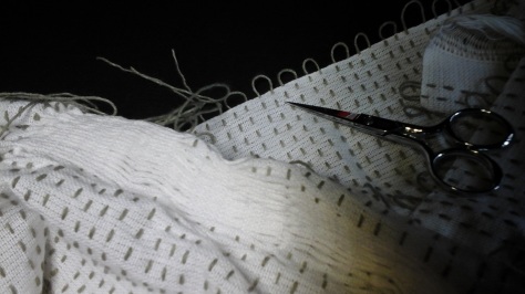 The start of gathering pattern threads on first long edge of scarf.